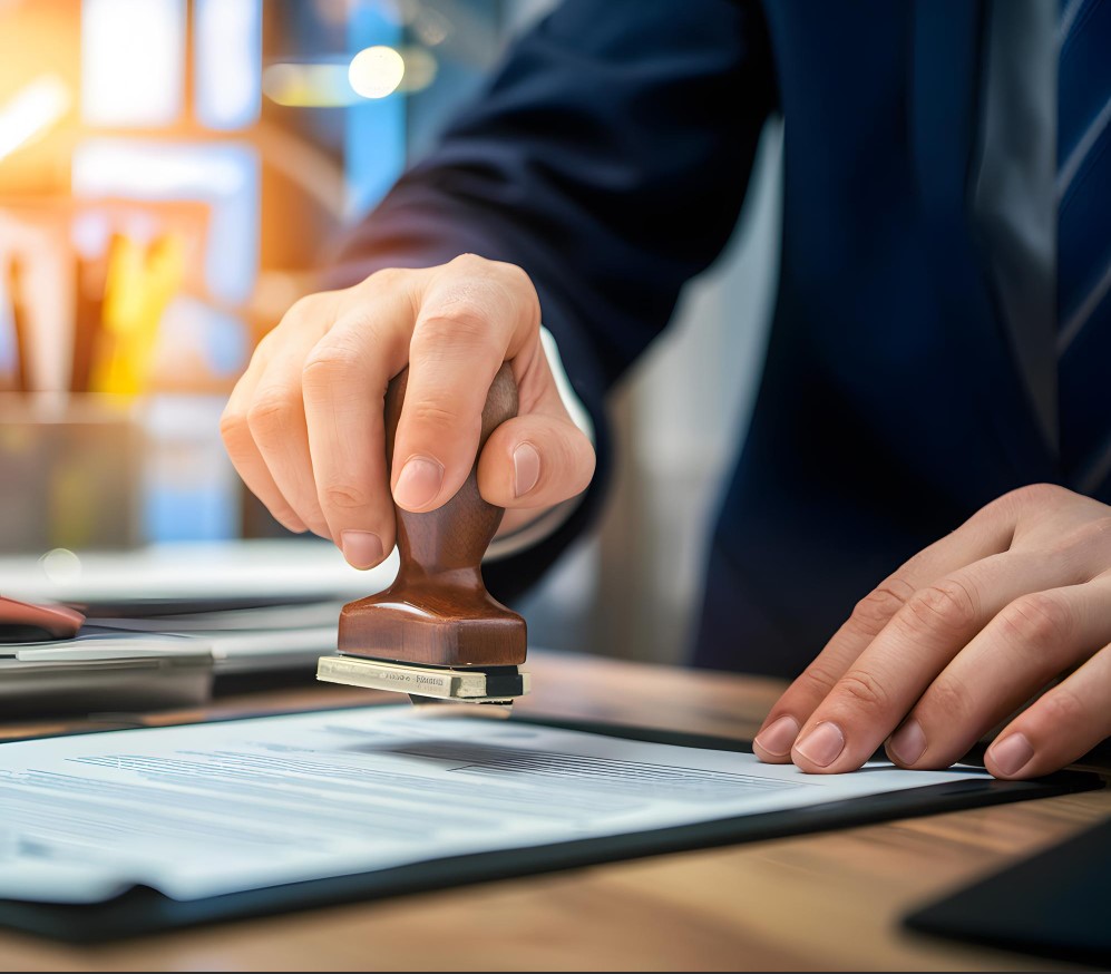A professional in a suit using a wooden stamp on an official document to validate a procedure and ensure compliance on a daily basis.